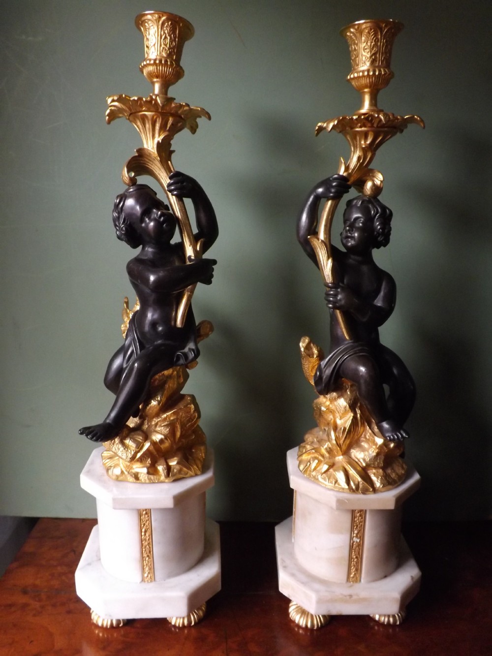 pair of late c19th french bronze and ormolu candlesticks on marble plinth bases