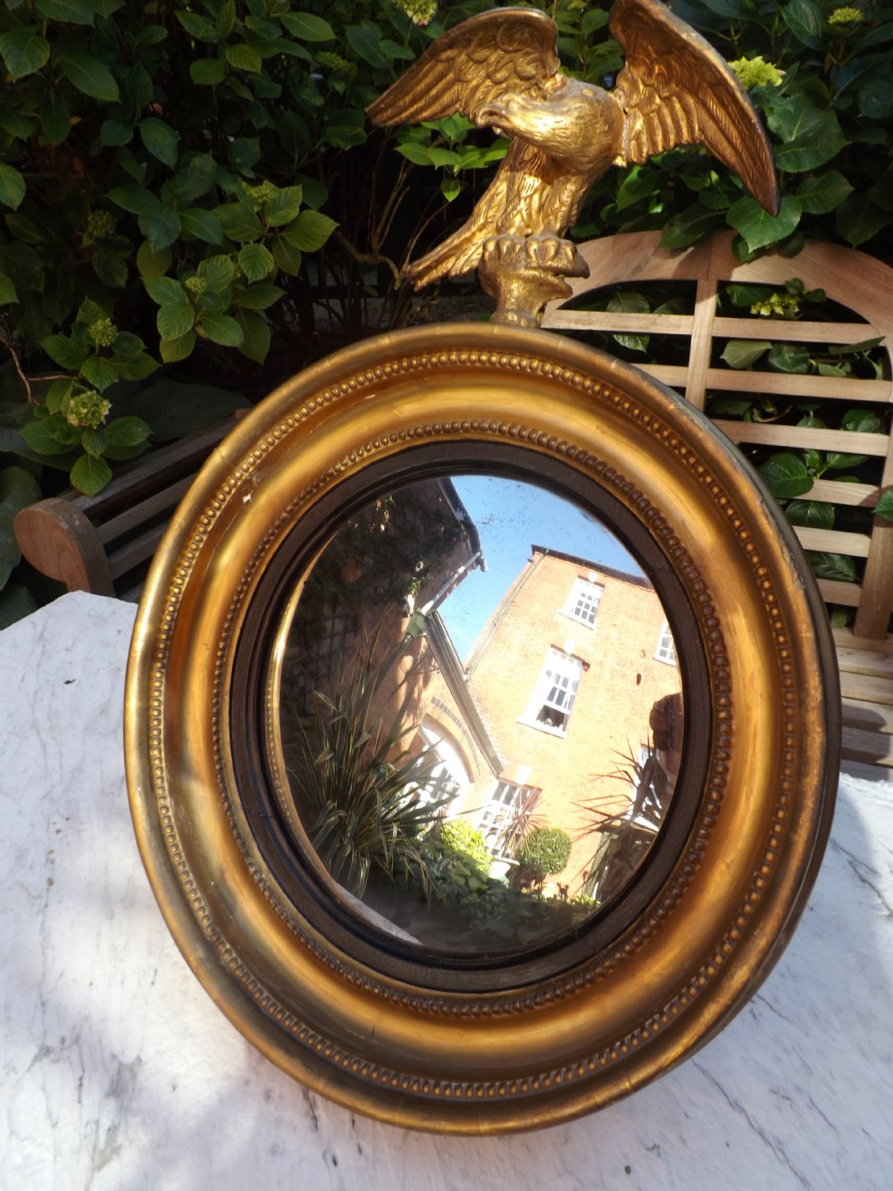 early c19th regency period miniature giltwood convexplate wall mirror