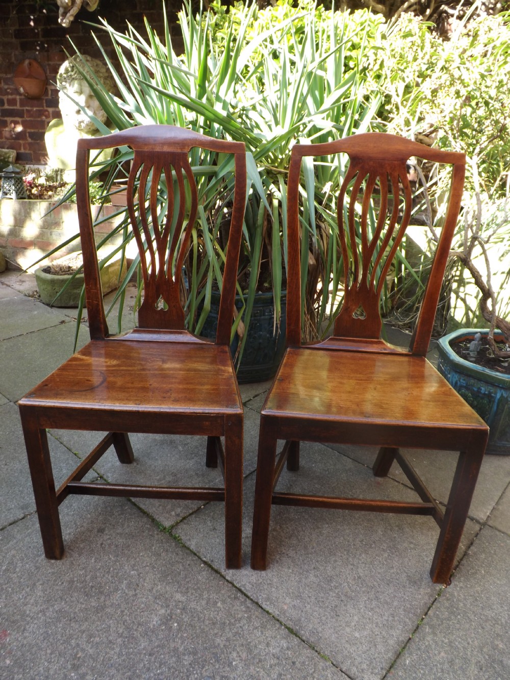 pair of c18th provinciallymade 'country chippendale' type alderwood sidehallchairs