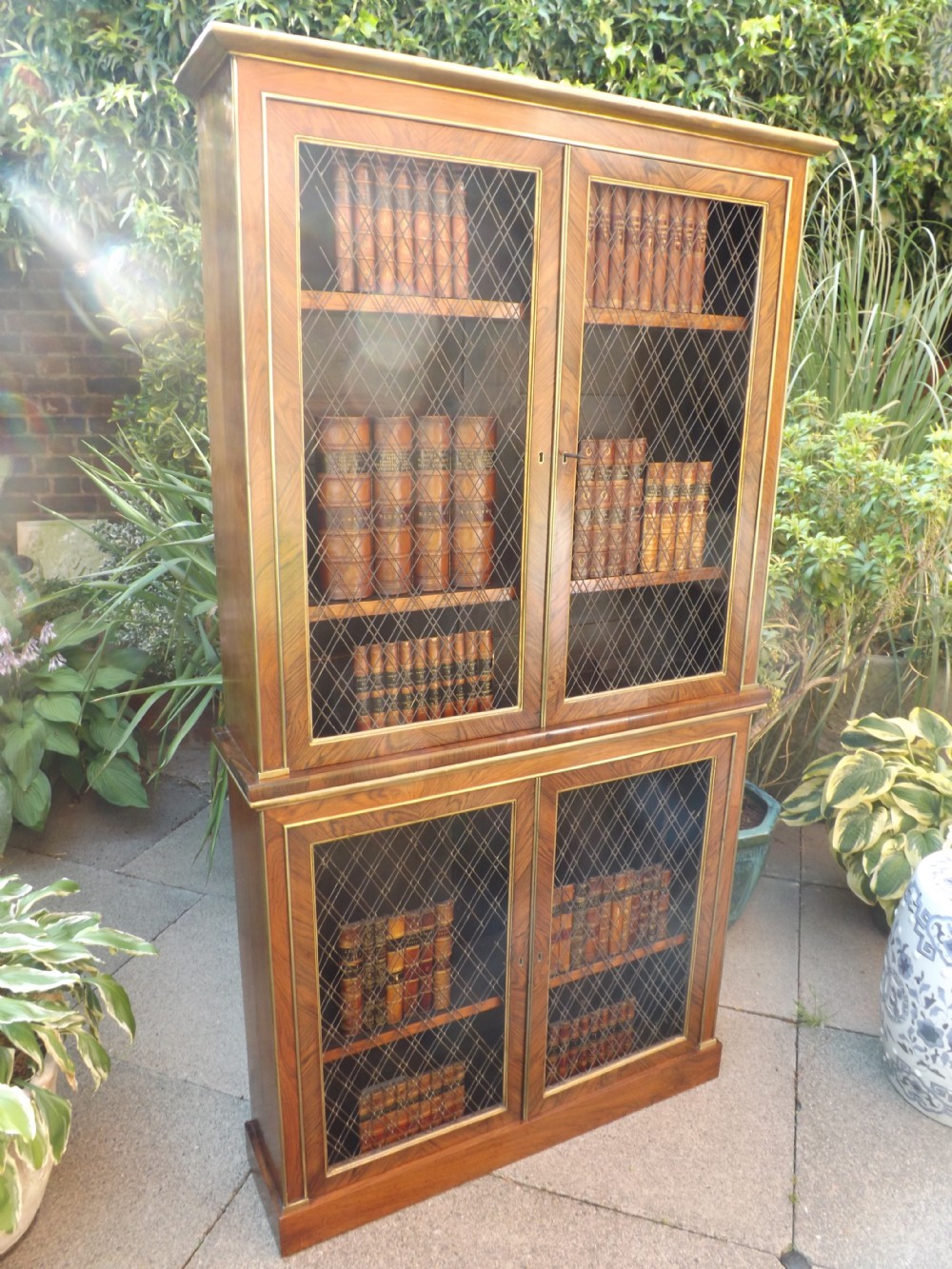 early c19th regency period rosewood gilt brassmounted and parcelgilt 2part bookcase