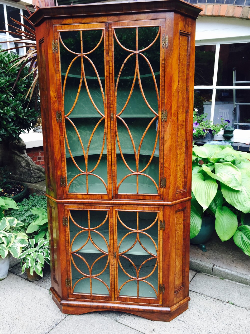 c19th george i revival walnut double cornercabinet with ovoid and diamond interlaced glazing