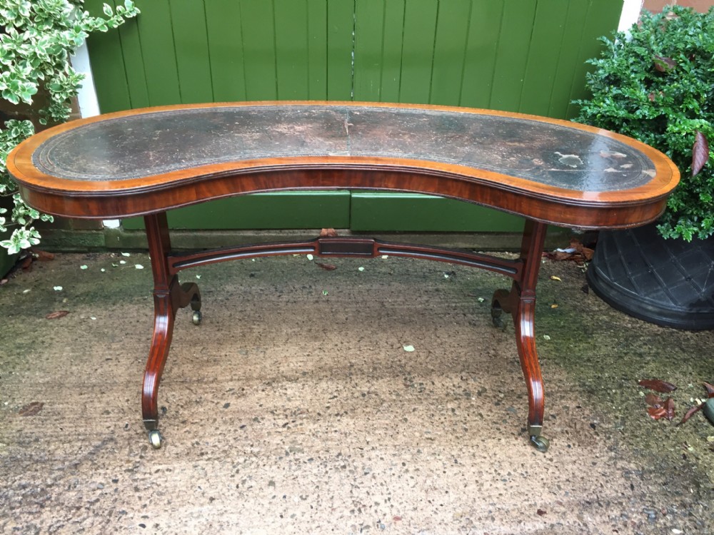 early c19th regency period mahogany writing library table of wide exaggerated 'kidney' form