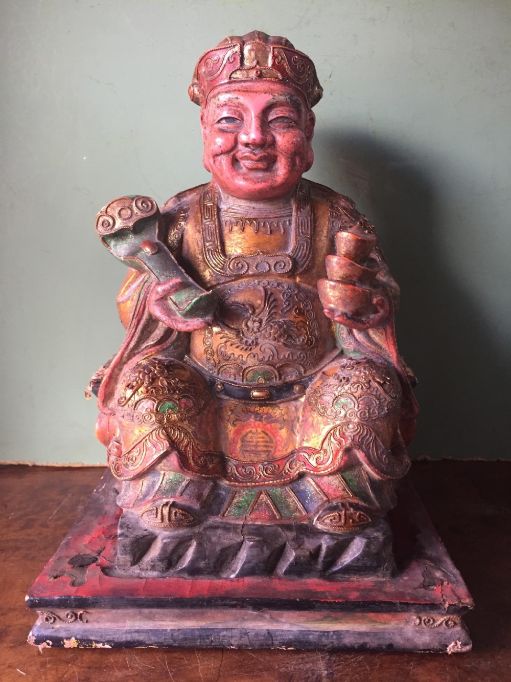 early c20th southeast asian lacquerwork and polychrome decorated seated hotei figure