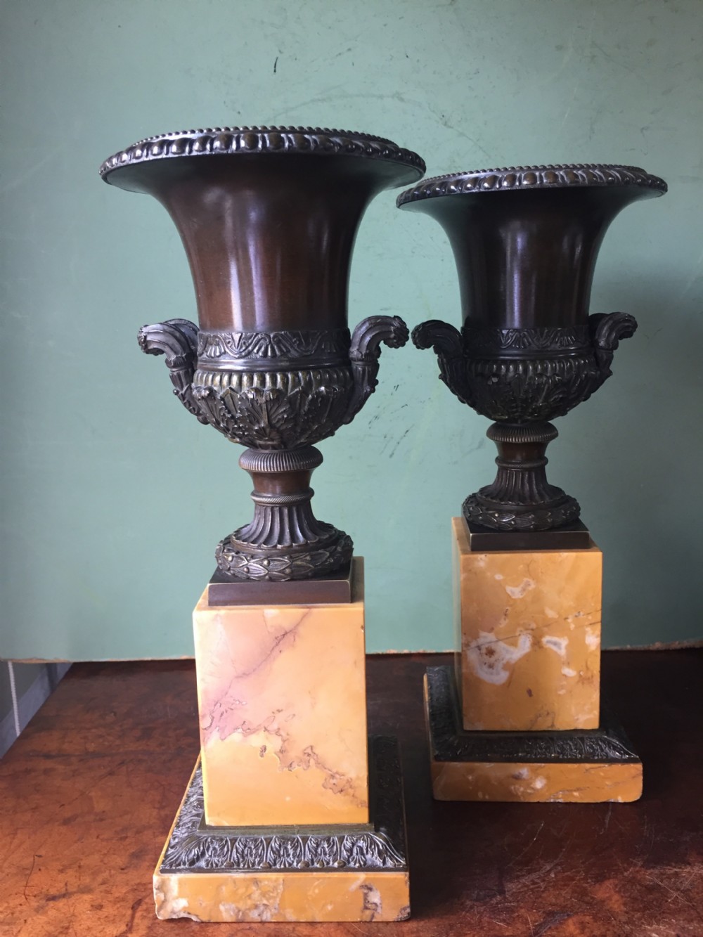 pair of french early c19th charles x period bronze campana shaped urns on siena marble plinth bases