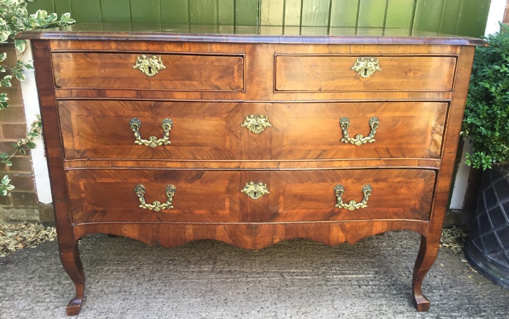 mid c18th italian olivewood fruitwood and walnut commode of serpentine outline