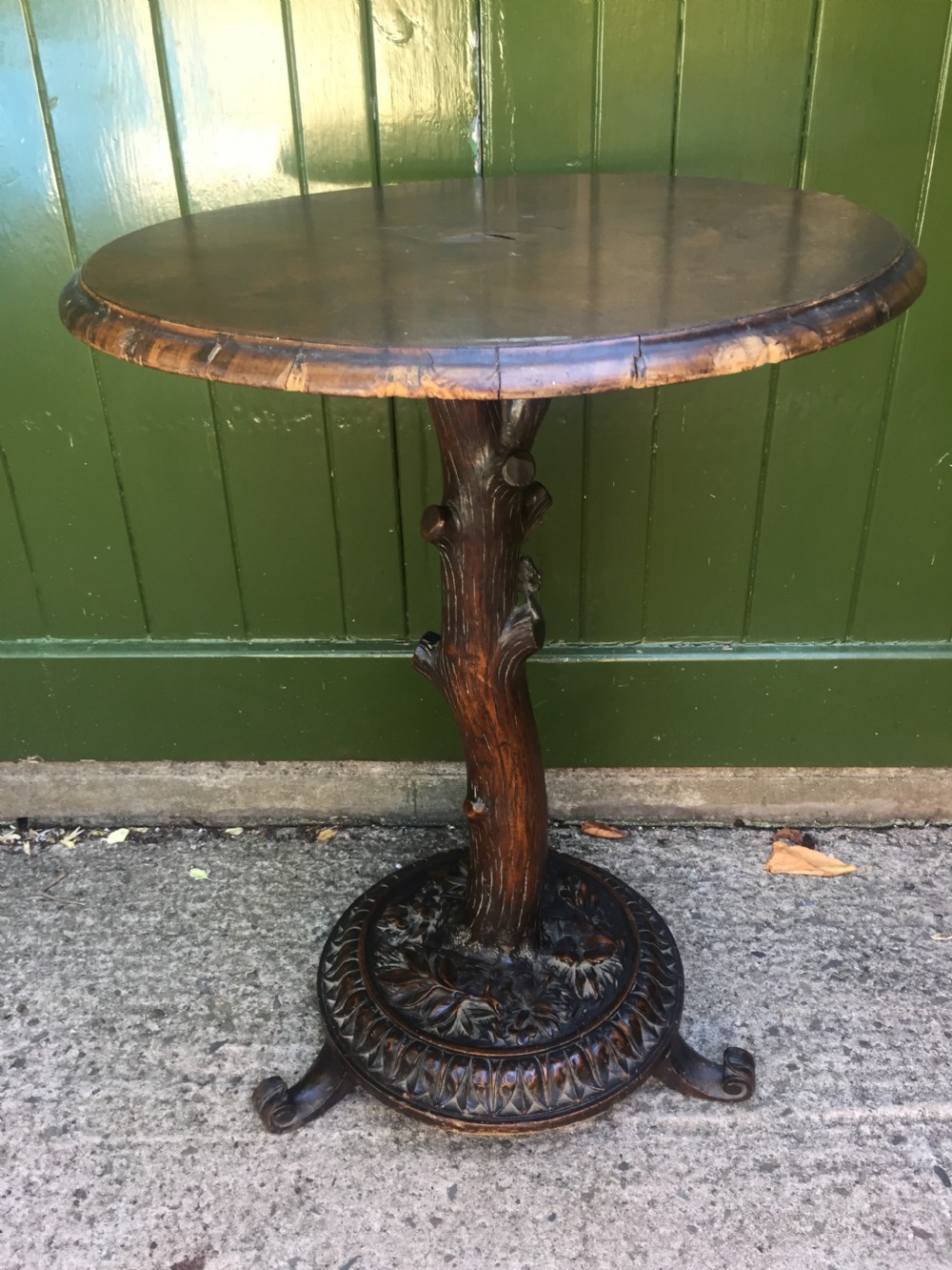 interesting late c19th 'black forest ' circular top linden wood table with naturalistically carved base