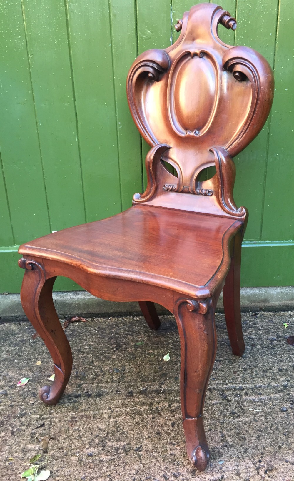 a high quality victorian mahogany hall chair of particularly bold and flamboyant design