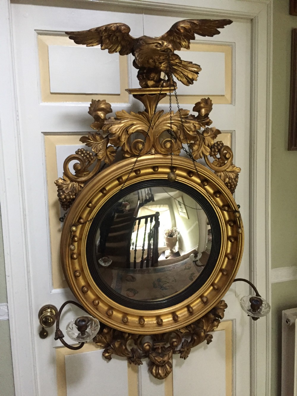 large and impressive regency period carved giltwood frame girandole convex mirror with eagle surmount
