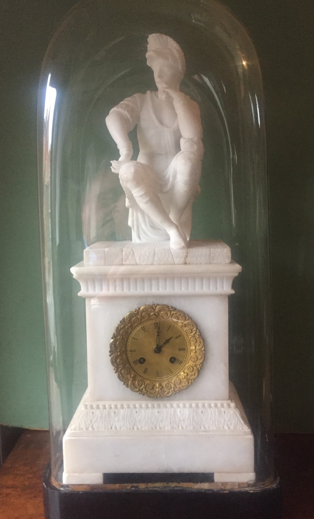 c19th italian carved alabaster mantel clock fitted with a french movement under glass dome