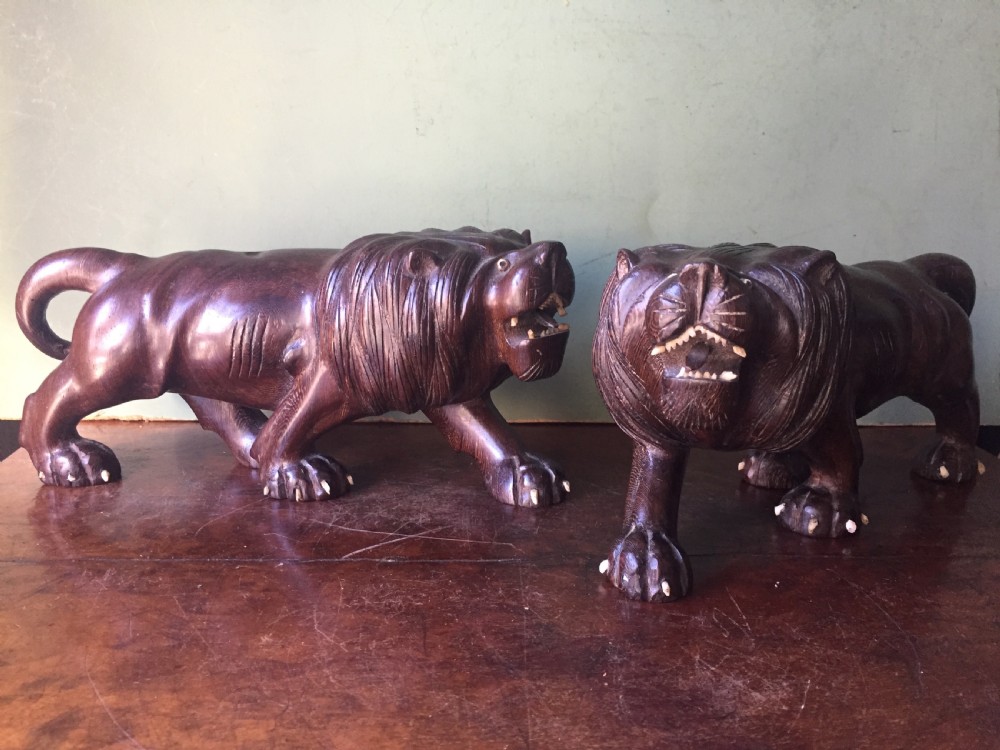 pair or early c20th japanese carved hardwood lions with carved bone details