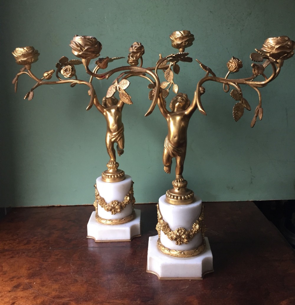 smart quality pair of french late c19th ormolu bronze and white marble cherub candelabras
