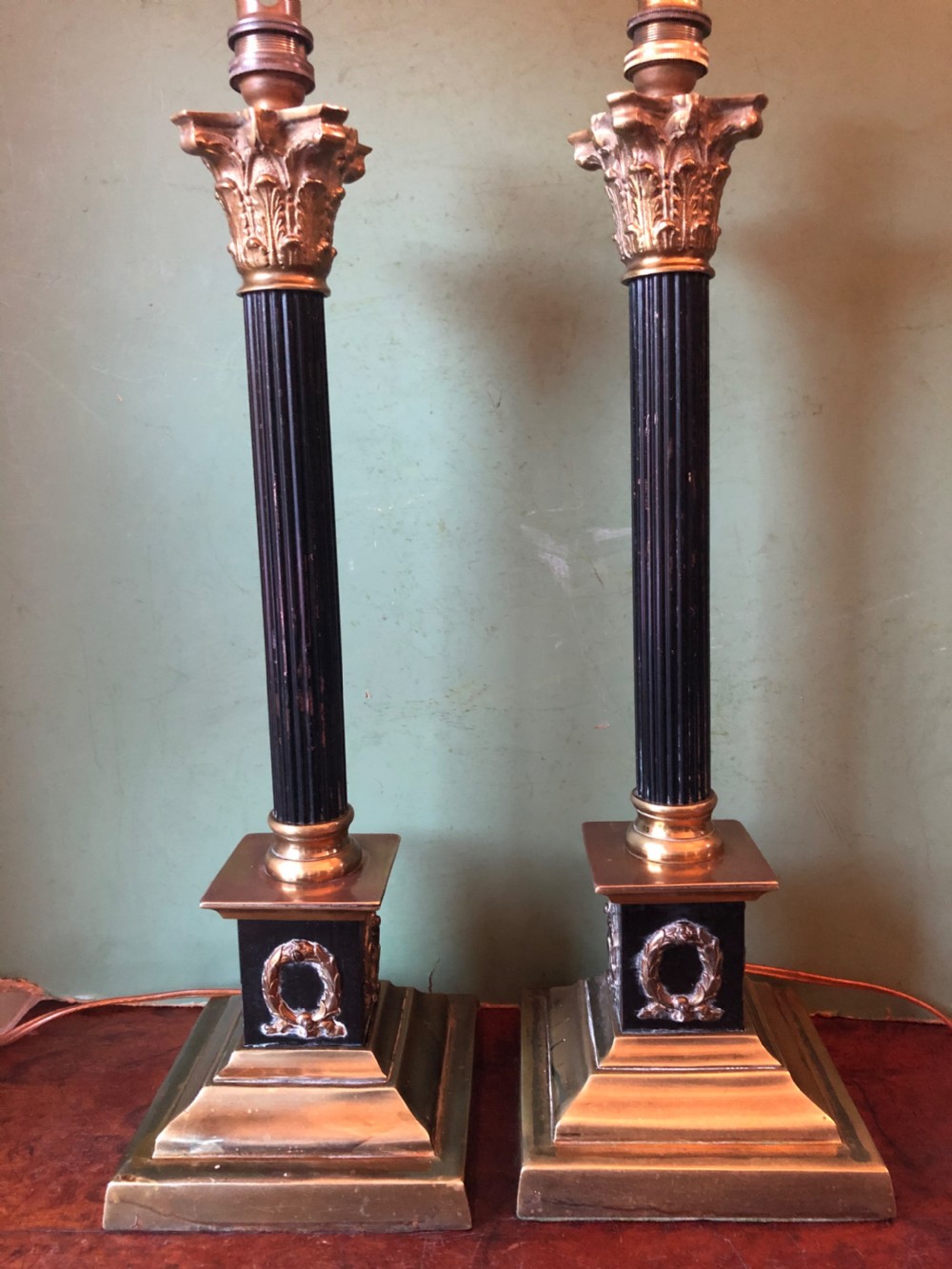 pair of early c20th patinated and polished brass table lamps of classical column form