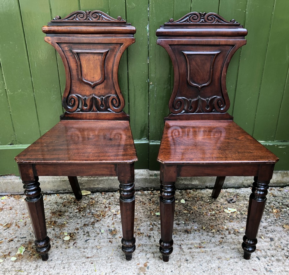 pair of early c19th george iv period mahogany hall chairs of grecian revival design