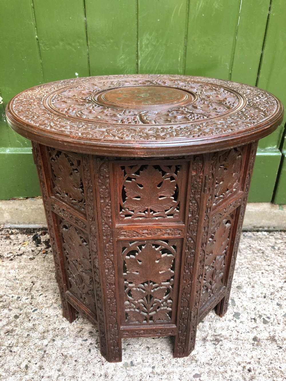 late c19th indian carved padauk circular occasional table with brass inlay on folding octagonal hinged base