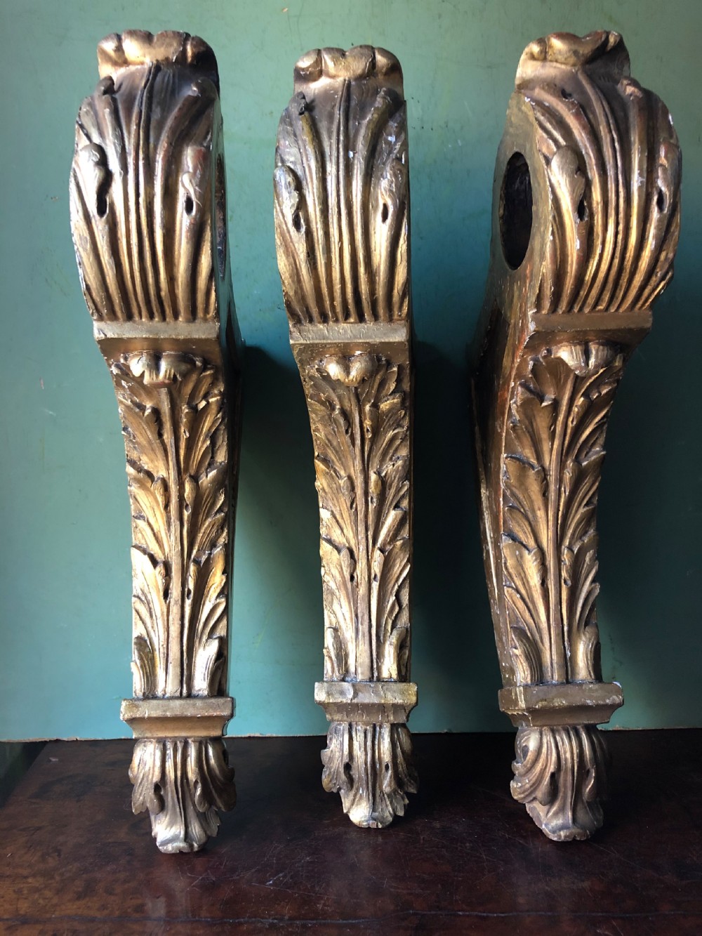 set of 3 mid c19th carved acanthusleaf decorated giltwood curtainpole brackets or supports