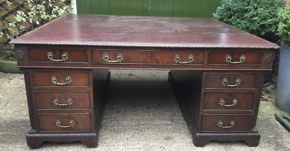 imposing c19th chippendalerevival style mahogany doublesided library desk