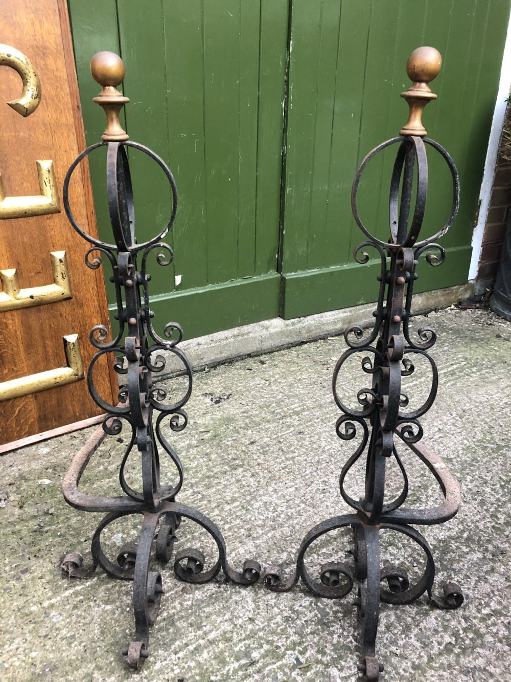 large pair of c19th wrought iron andirons with turned brass ball finials in the c17th taste