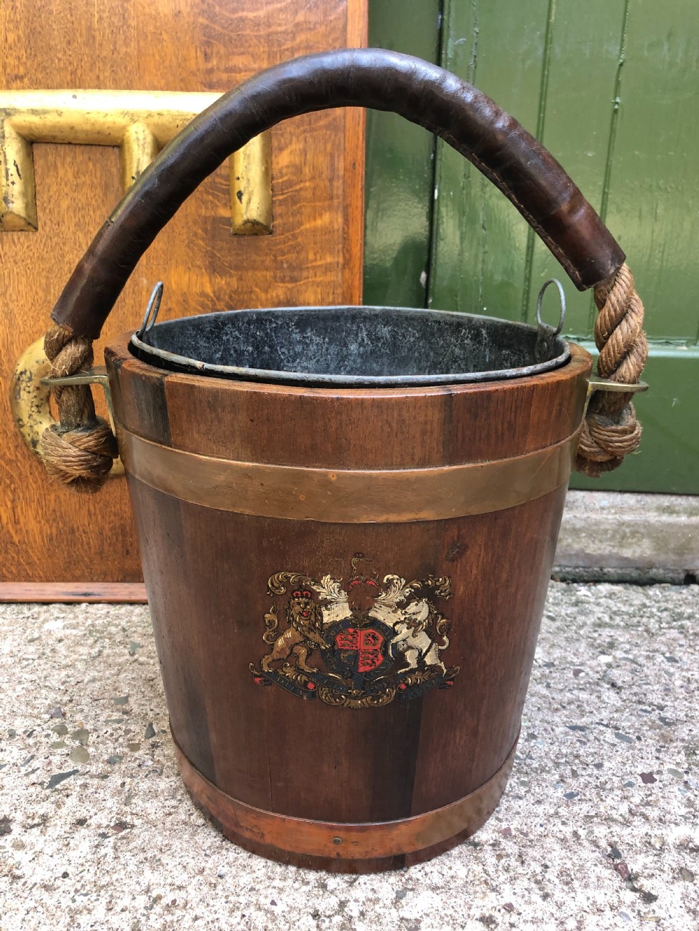 c19th naval teak firebucket with armorial crest leathercovered rope handle and copper ring banding