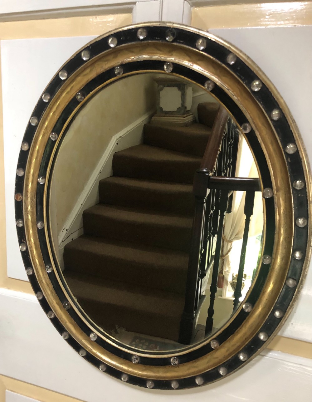 c19th irish oval mirror with ebonised and gilded glass facet mounted frame with silvered outer edge