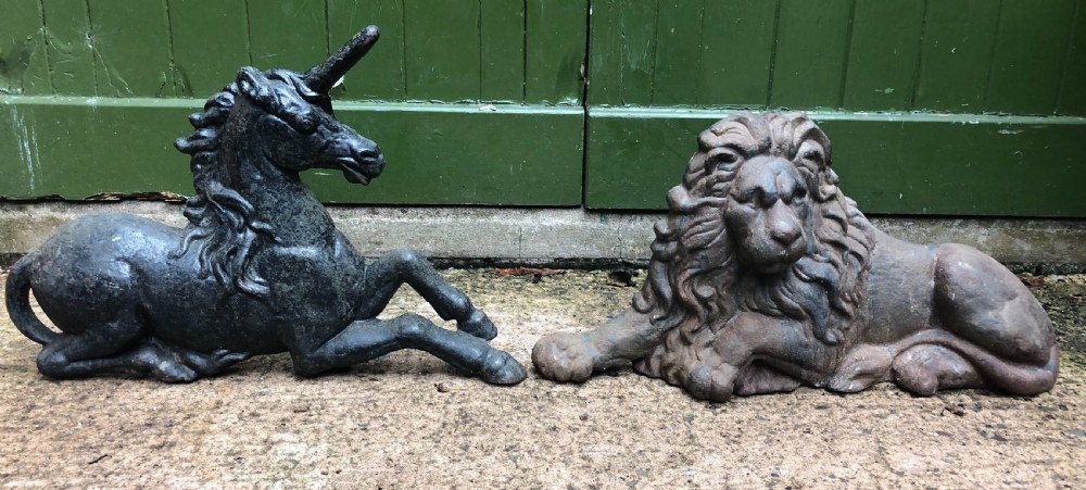 pair of mid c19th castiron bootscrapers in the form of a recumbent lion and a unicorn