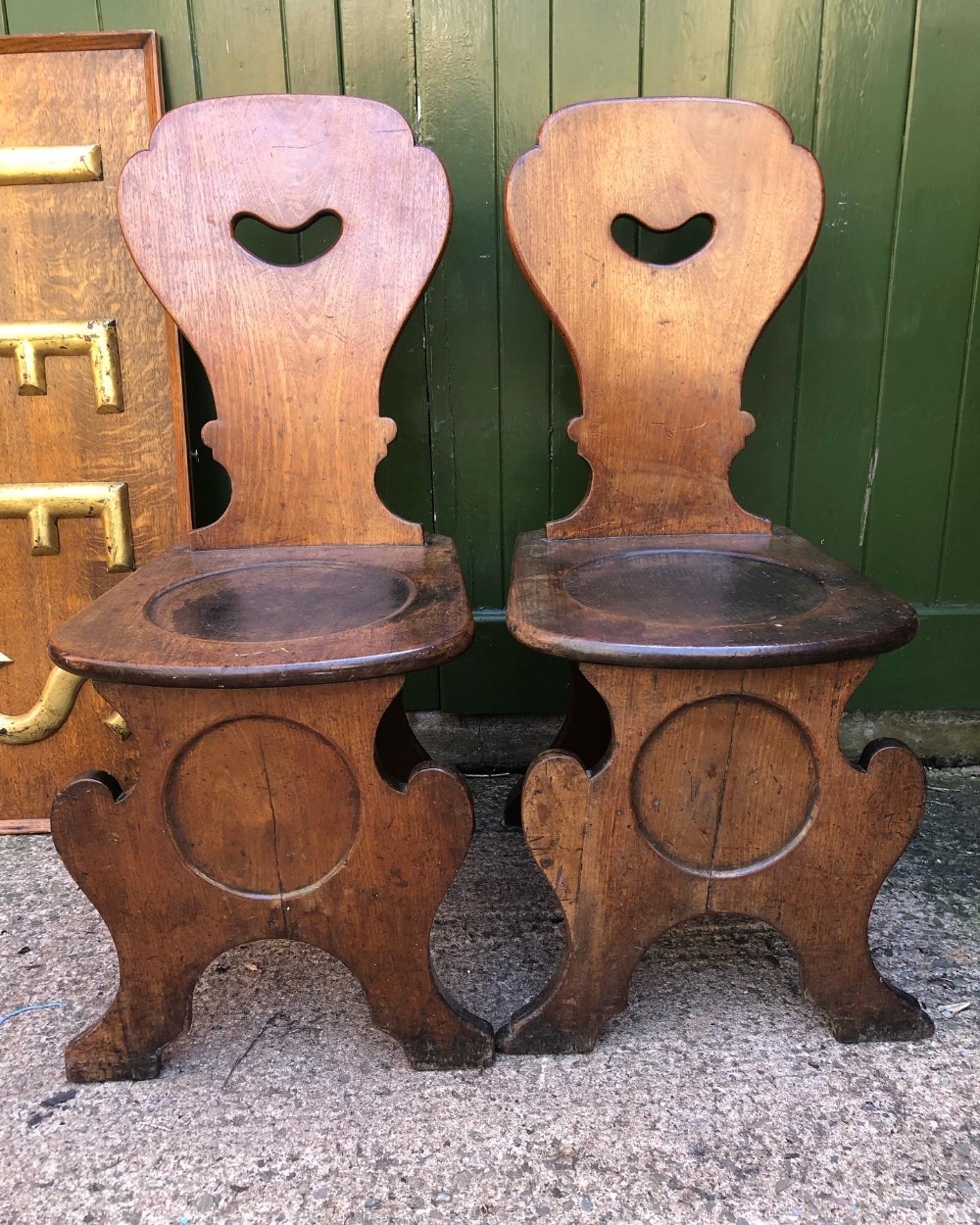 pair of mid c18th george ii period mahogany hall chairs of sgabello design
