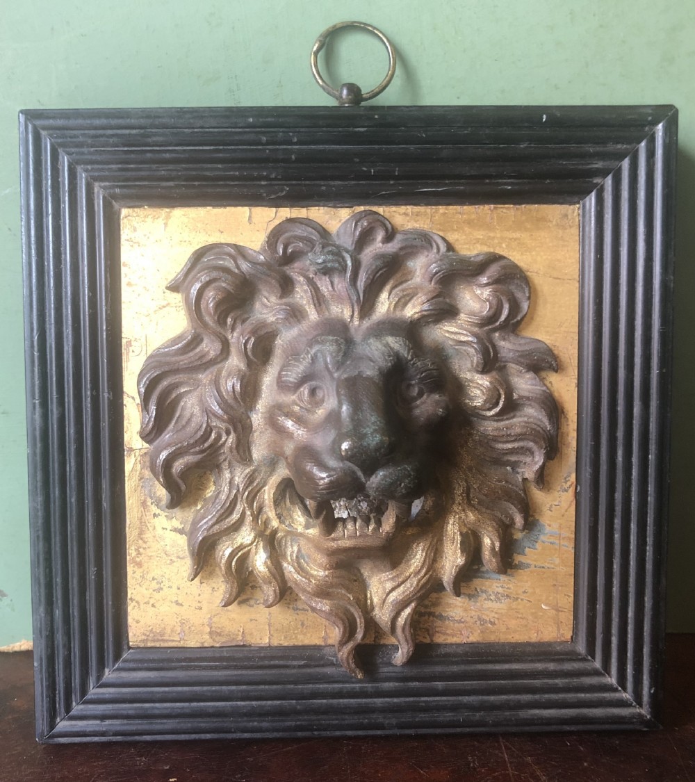 interesting early c19th regency period gilt bronze lions mask on a gilded panel within a reeded ebonised frame verso with original trade label
