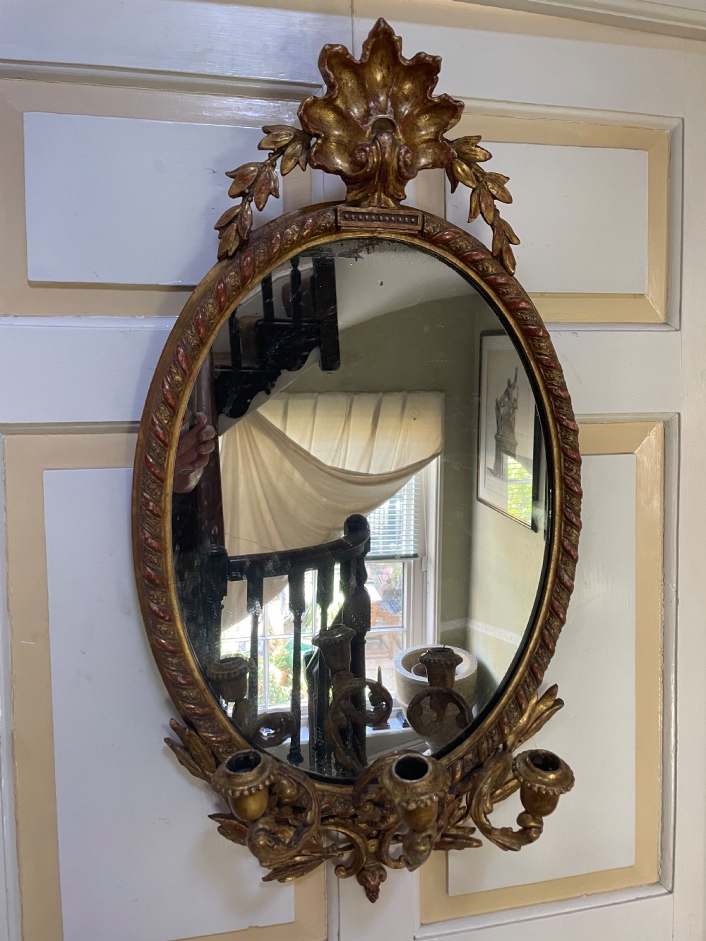 mid c19th carved giltwood framed oval mirror with triple branch candlearms