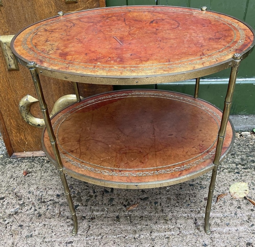 early c20th french brassframed oval 2tier low etagere with gilttooled leather tops