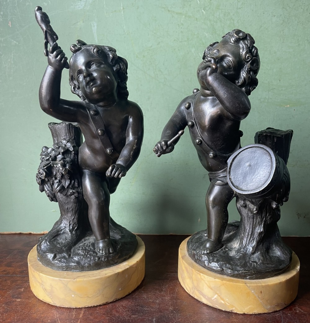 pair of early c19th french bronze allegorical sculptures of cherubs emblematic of music and comedy after clodion