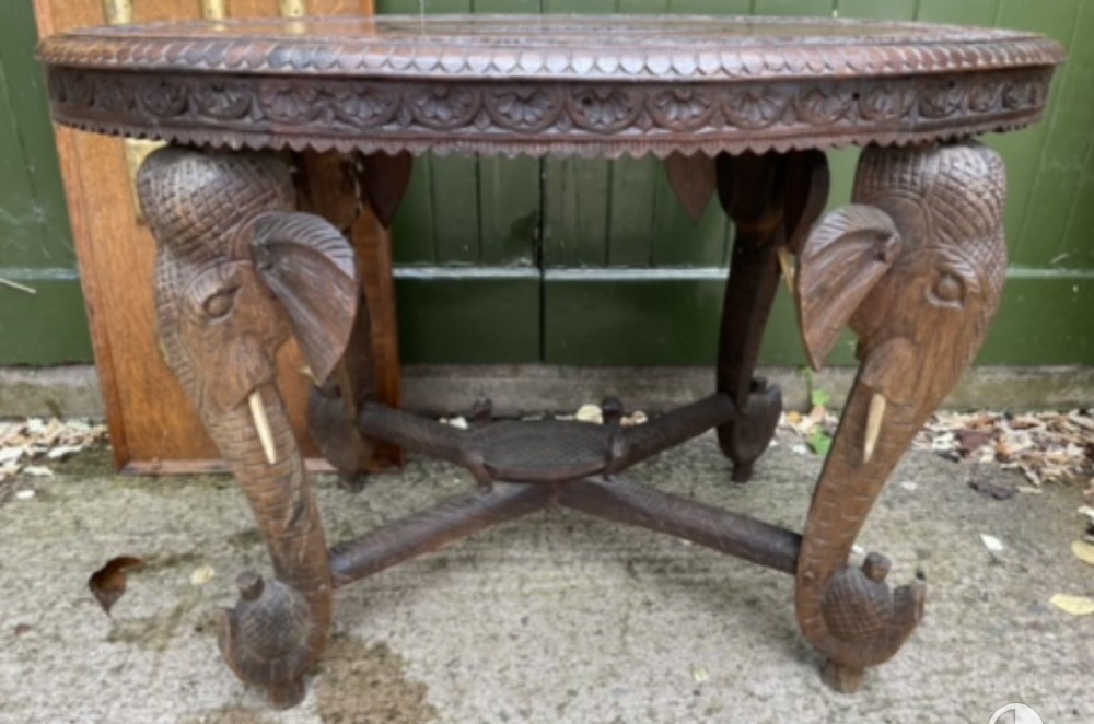 early c20th british india period profusely carved oval teak table on elephants head supports