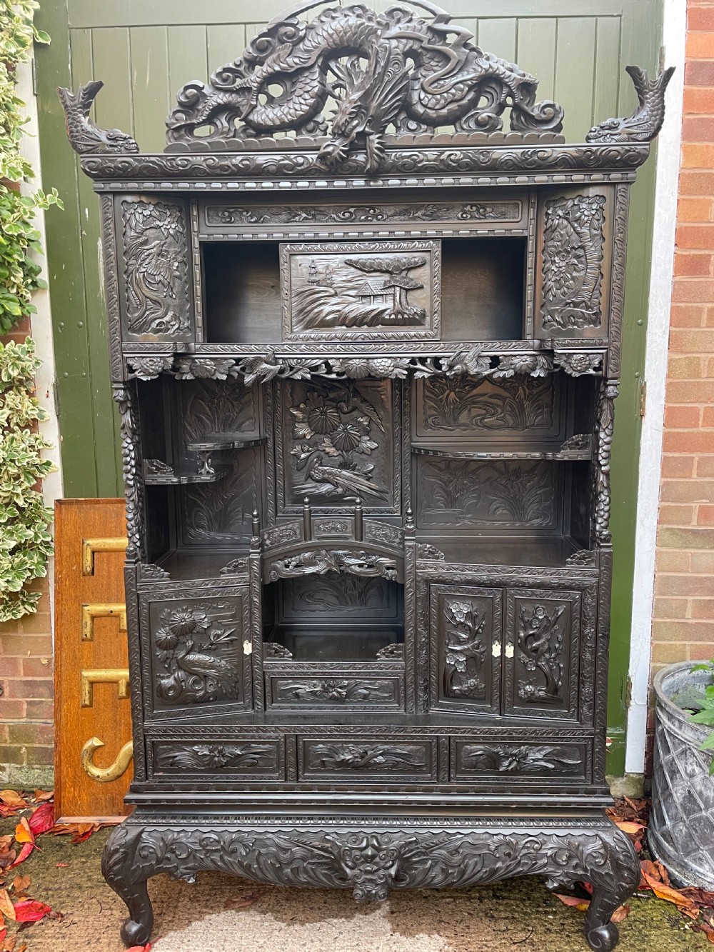 early c20th japanese taisho era carved and ebonised shodana or display cabinet on stand