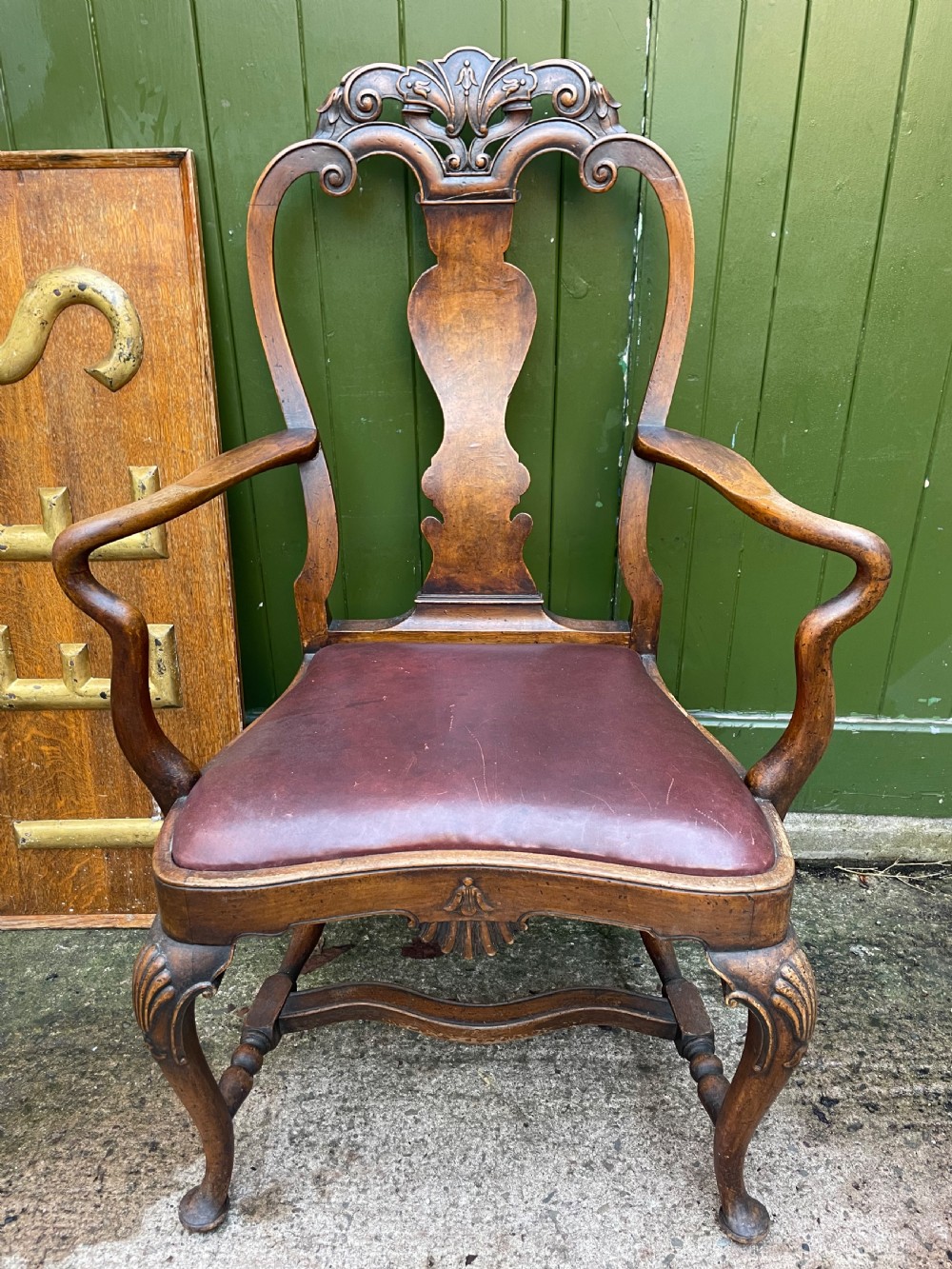 a late c19th early c20th carved walnut armchair of queen anne period revival design