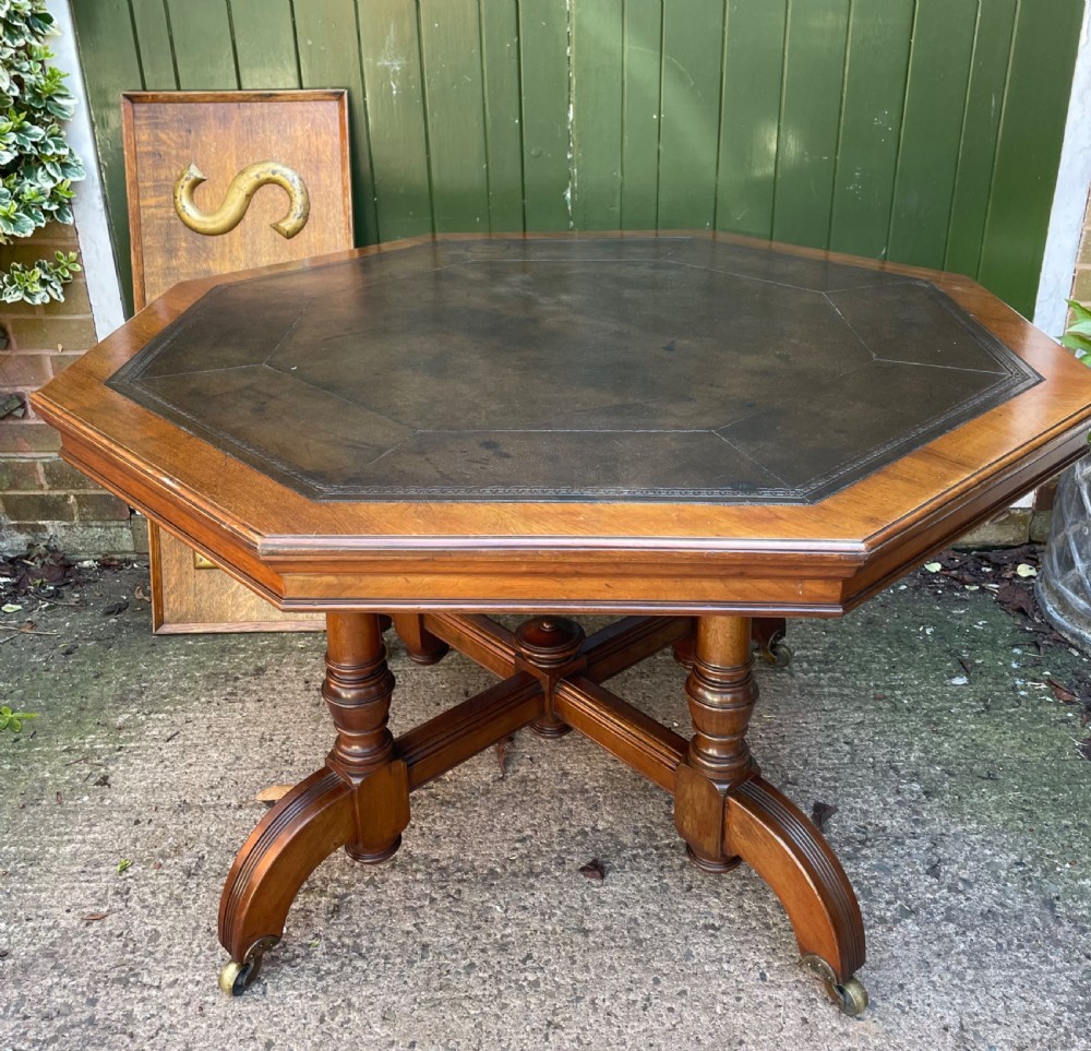 late c19th octagonal walnut reformed gothic style walnut centre or library table retaining the original tooled moroccan leather inset top