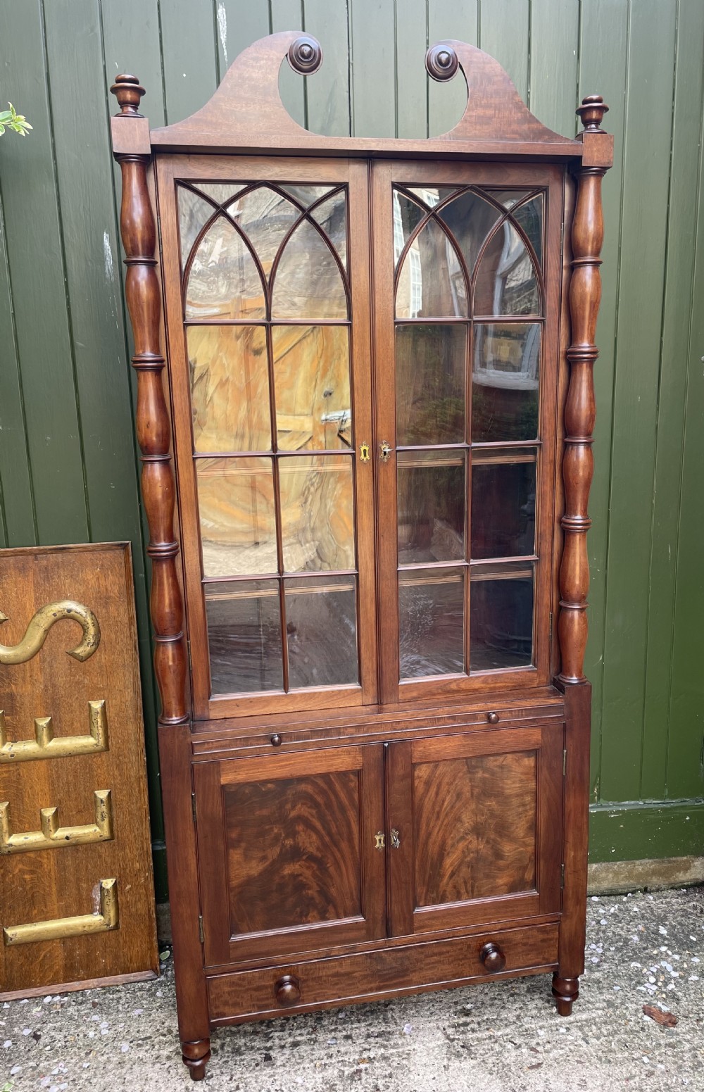 early c19th regency period mahogany bookcase cabinet of unusual form and design