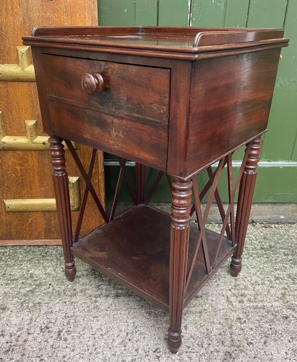 early c19th mahogany bedside table of empire inspired design on reeded legs