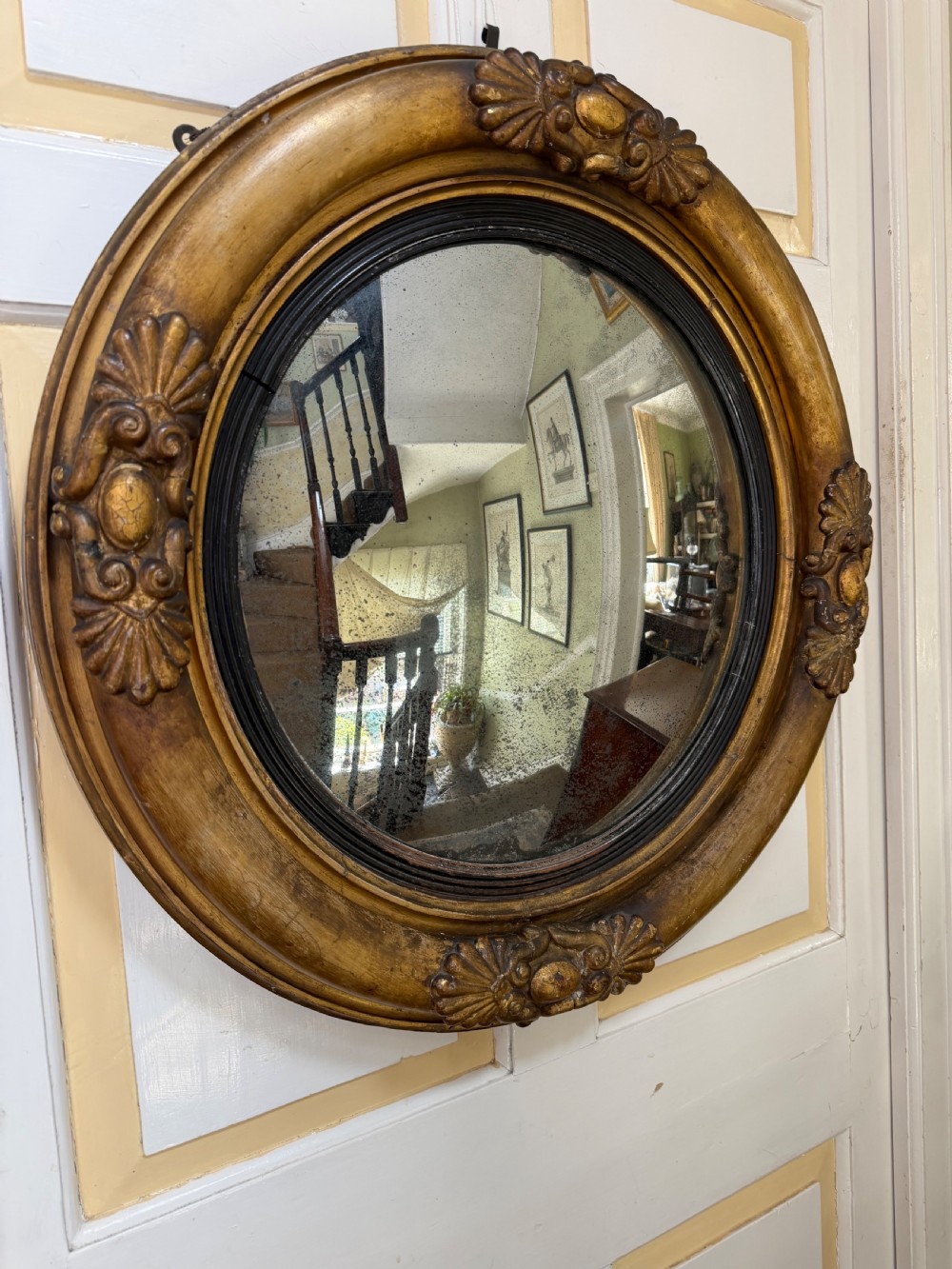 early c19th regency period giltwood framed convex plate mirror of larger scale and proportions