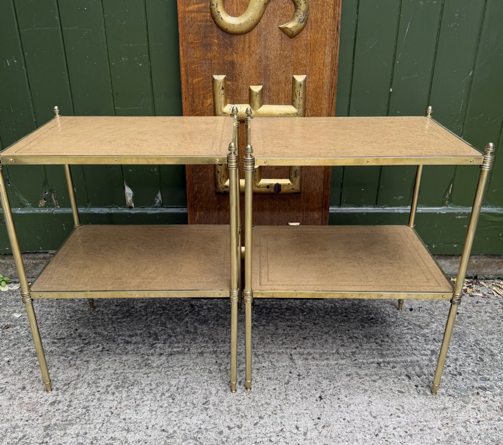 chic pair of early c20th lacquered brassframed etageres with inset tooled panel leather shelves