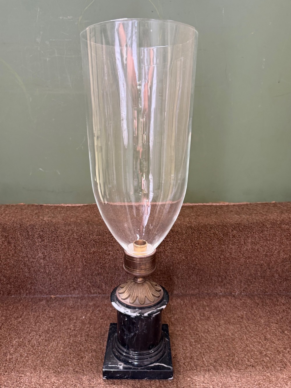 large mid c20th candlelamp or photophore of early c19th design with a tall glass atom shade raised on a patinated bronze holder onto cylindrical marble base with a plinth foot