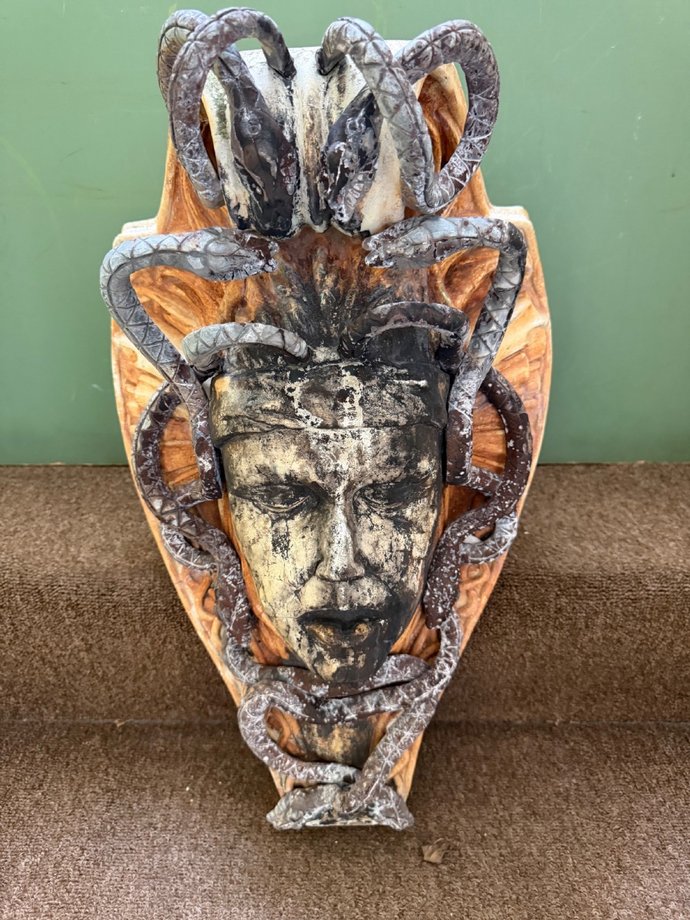 highly decorative early c20th carved stone and leadmounted medusa head wallbracket